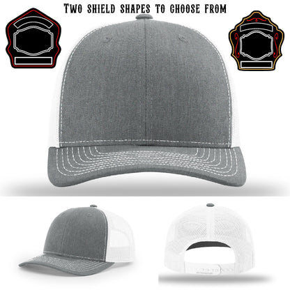 Fire department hat displayed with two shield patch examples
