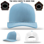 Firefighter hat displayed with two variations of shield patches