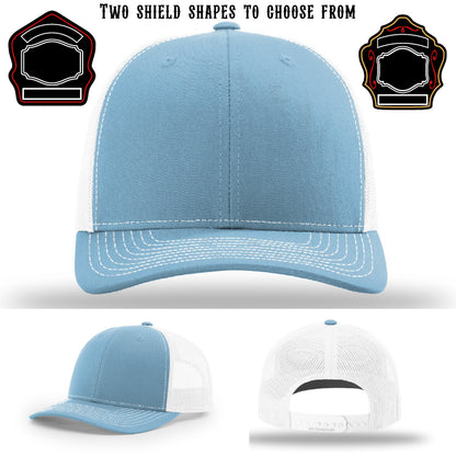 Firefighter hat displayed with two variations of shield patches