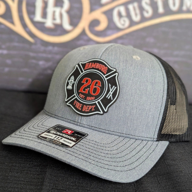 Rugged firefighter hat showing detailed Maltese cross patch in color