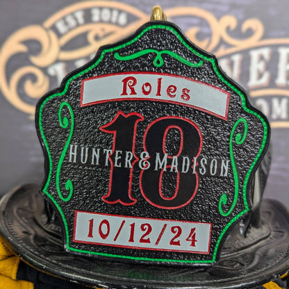 Green medallion leather firefighter helmet shield with banner/date detail on black