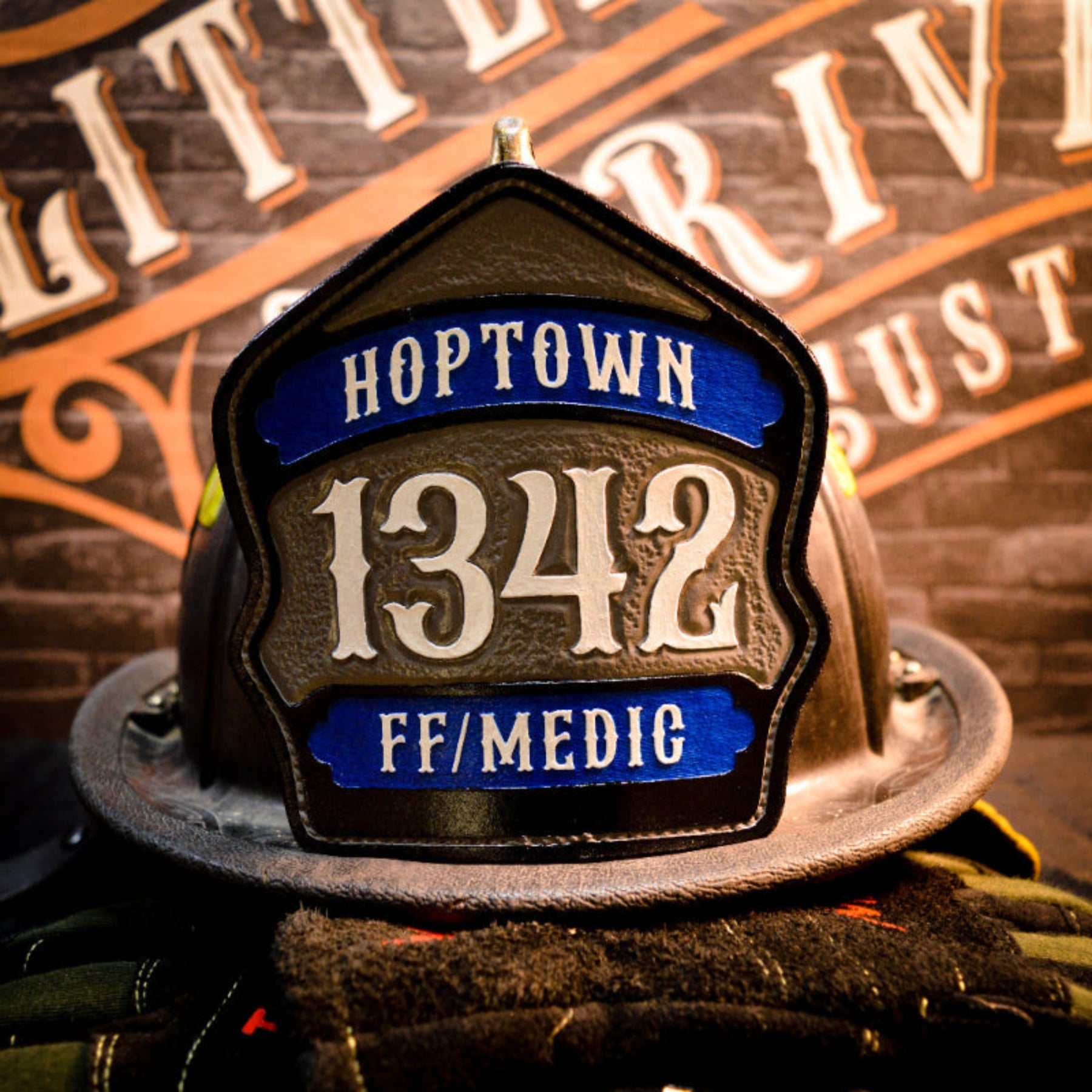 Gray center-panel leather firefighter helmet shield with black banners and white numerals.