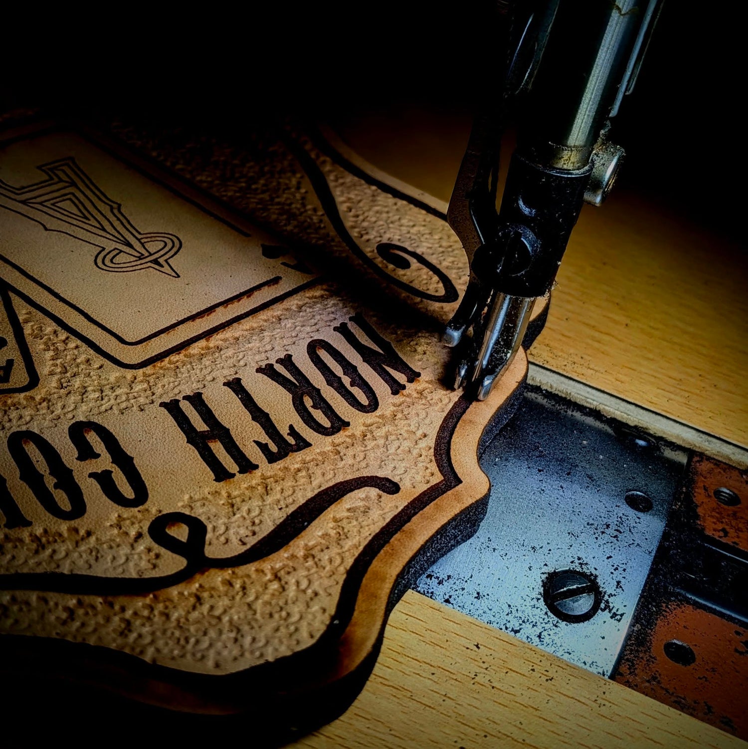 Hands on leather production work at custom gear shop