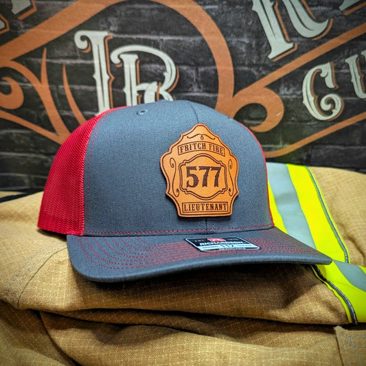Custom firefighter hat featuring traditional leather shield patch with station pride