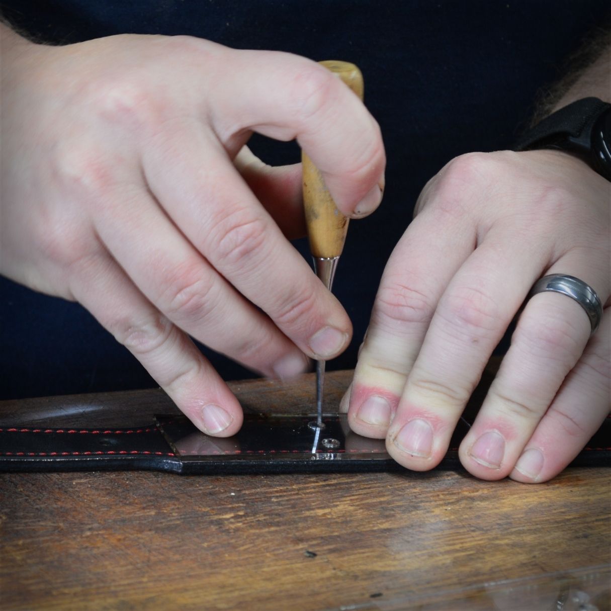 Little River Customs workshop photo showing leather crafting process for custom firefighter shields and hats