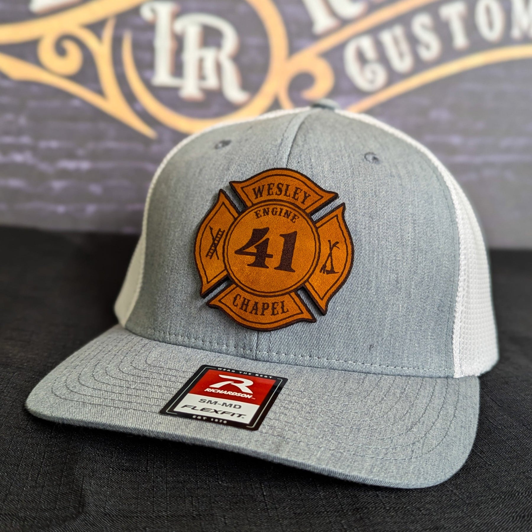 Light gray Richardson firefighter hat with custom Maltese leather patch design, Flexfit style built for fire department crews.