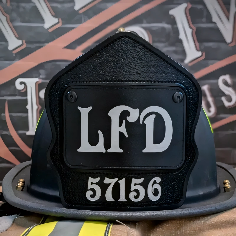 Hand-tooled passport firefighter helmet shield showing clean lettering in leather