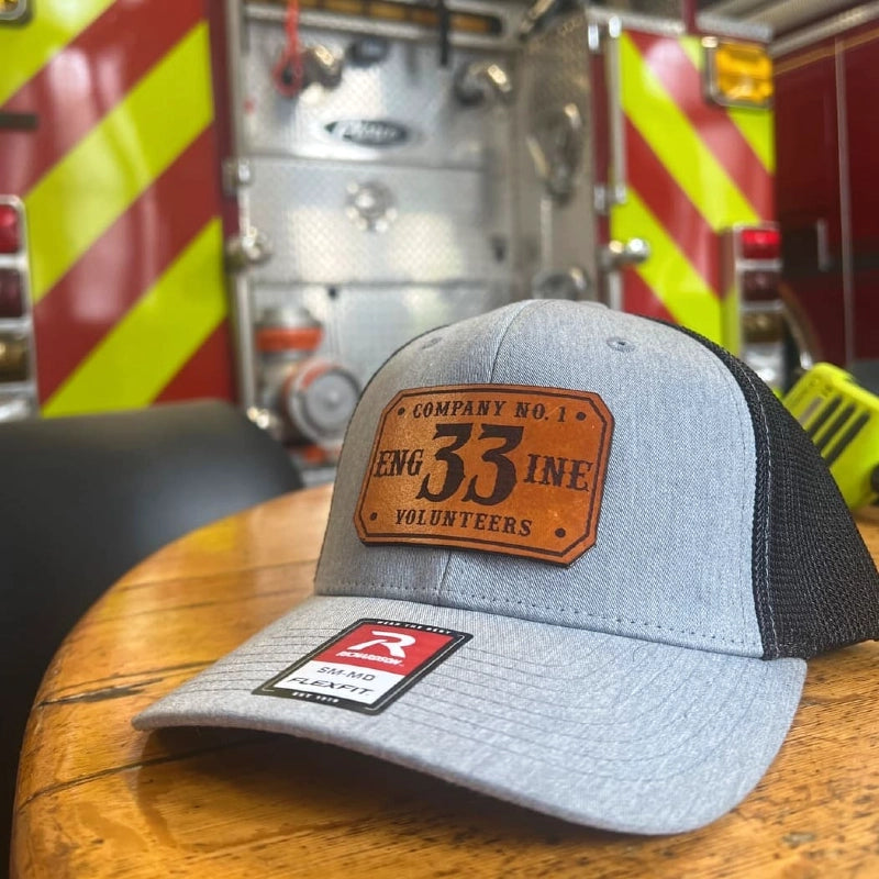 Firefighter station hat with passport leather patch showing rank and department