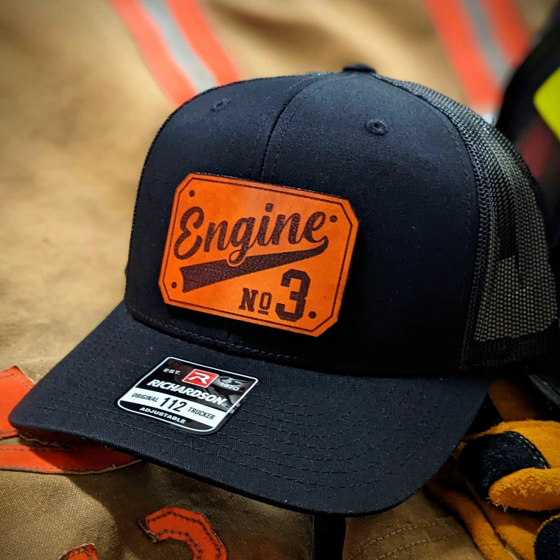 Rugged firefighter hat showing bold passport leather patch with clear design