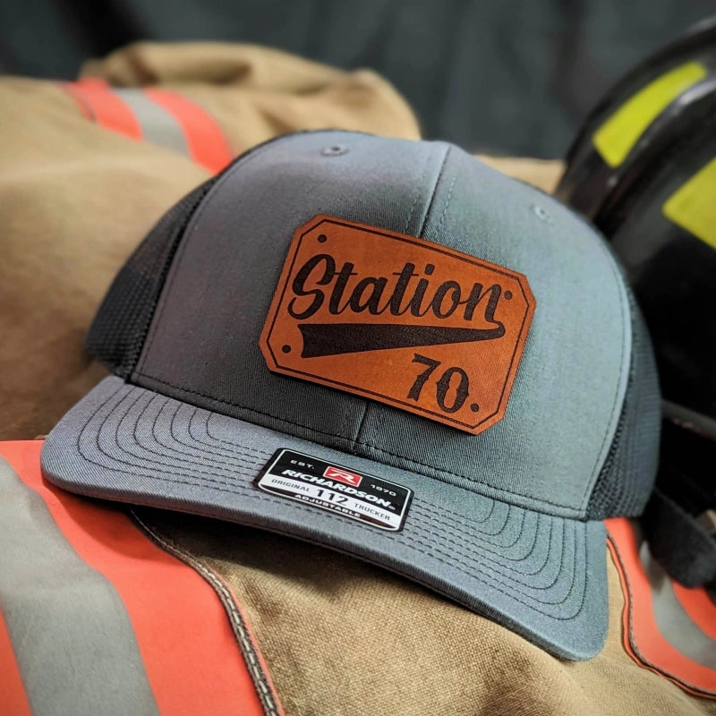 Station apparel hat with passport leather patch showing department pride