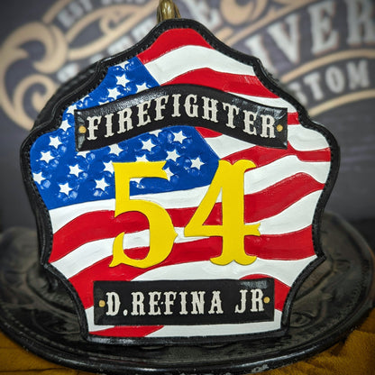Custom firefighter helmet shield with American flag design, personalized leather front with unit number and firefighter name. Handcrafted fire helmet shield for professional firefighters, made for durability and pride on the job.