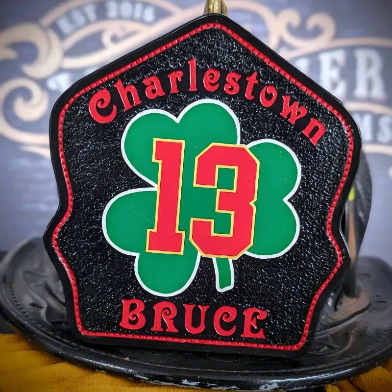Firefighter helmet shield with green shamrock emblem
