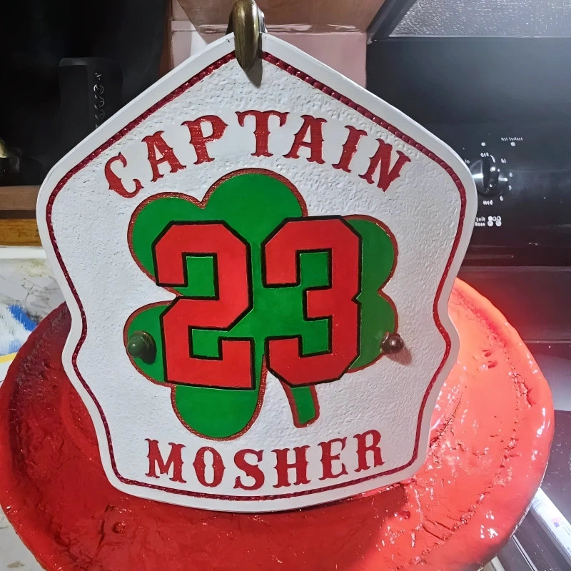 Durable leather shield for firefighters featuring shamrock motif