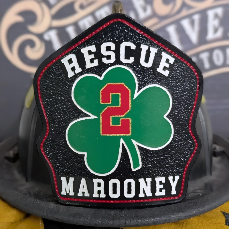 Handcrafted firefighter helmet shield in leather featuring bold shamrock design