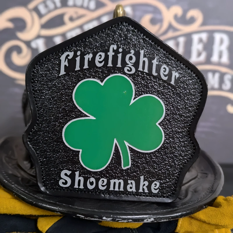 Durable leather firefighter helmet shield styled with shamrock firehouse layout