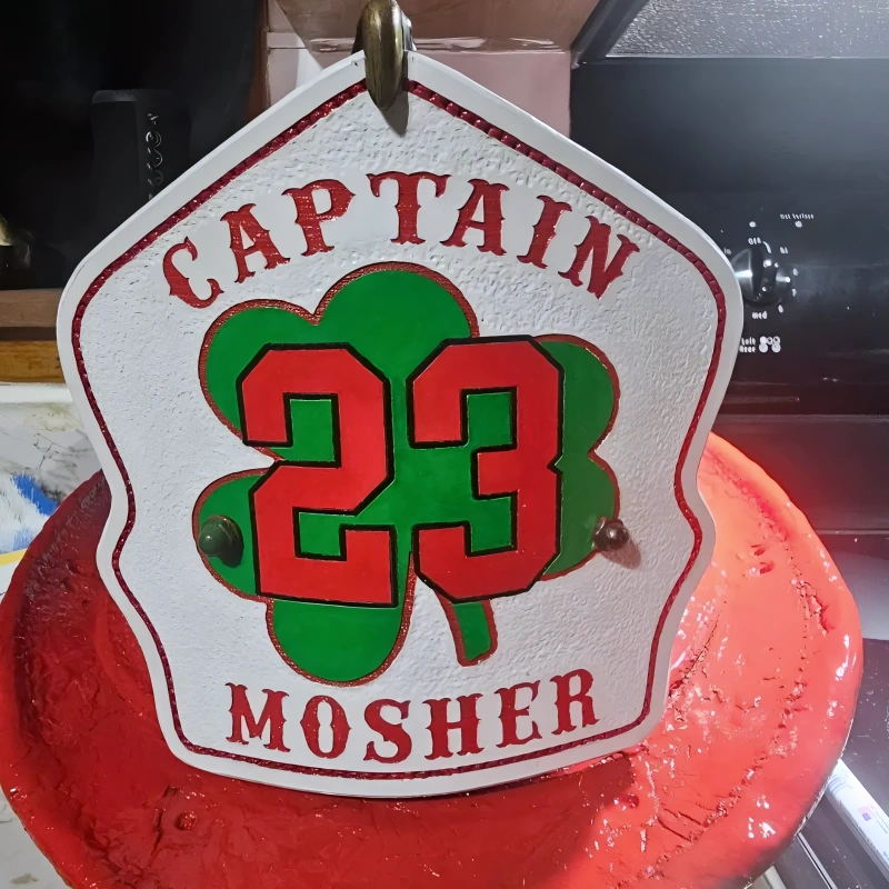Customizable leather firefighter helmet shield designed with shamrock details for fire crews