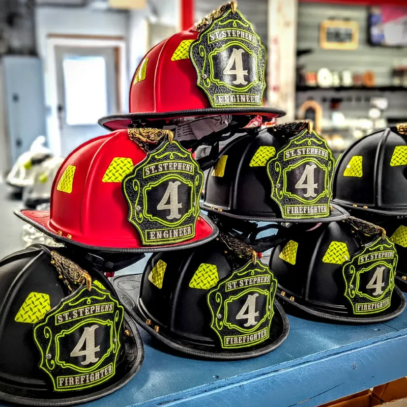Standard Issue custom leather firefighter helmet shields displayed on black and red helmets with bold number design.