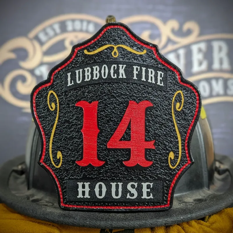 Standard Issue custom leather firefighter helmet shield in black with bold red numbers, white department text, and gold decorative accents.