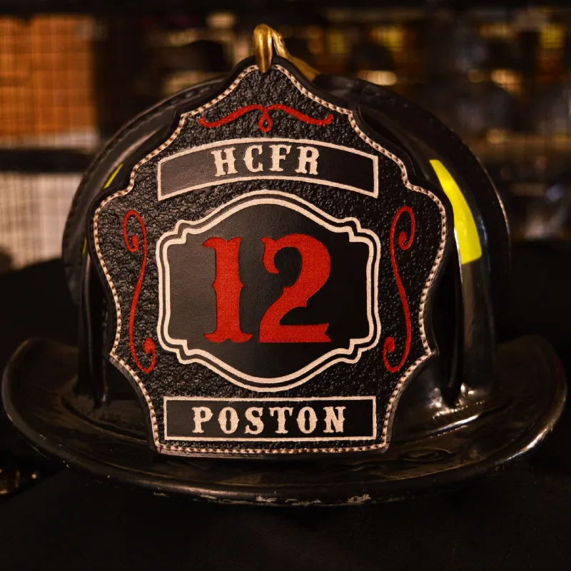 Standard Issue custom leather firefighter helmet shield in black with red numbers and white border detail.