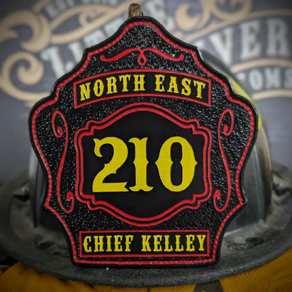 Standard Issue custom leather firefighter helmet shield for Chief in black with yellow numbers, red trim, and gold department text.