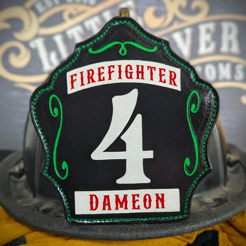 Standard Issue custom leather firefighter helmet shield for Firefighter in black with white numbers, red lettering, and green trim accents.