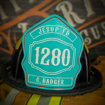 Standard Issue custom leather firefighter helmet shield in teal with white numbers, department text, and red trim accent.
